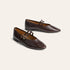 A pair of dark brown leather Mary Jane flats with pointed toes and double buckle straps, displayed on a light beige background.